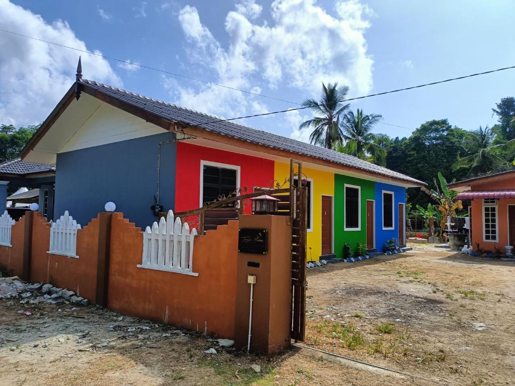 a colorful house with a fence in front of it at The Marak Village KB - Mini Homestay in Kota Bharu