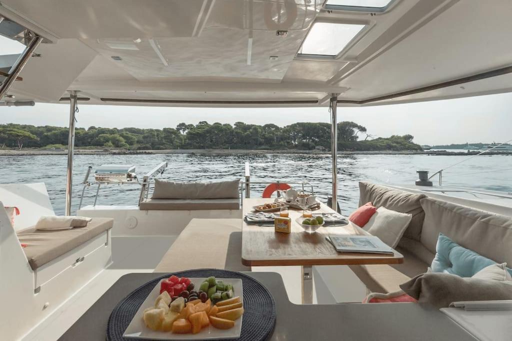 a table on a boat with a plate of food at LUXE Crewed Catamaran, Sailing Mangofloat, Croatia in Split
