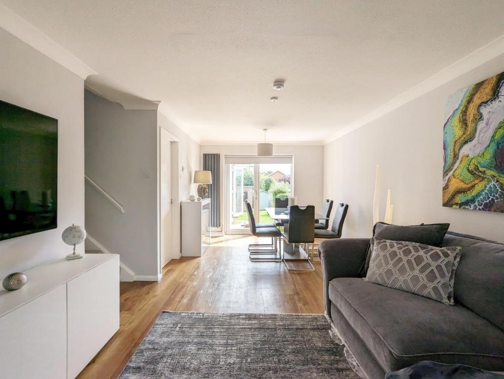 a living room with a couch and a table at Brook House - Emsworth in Emsworth