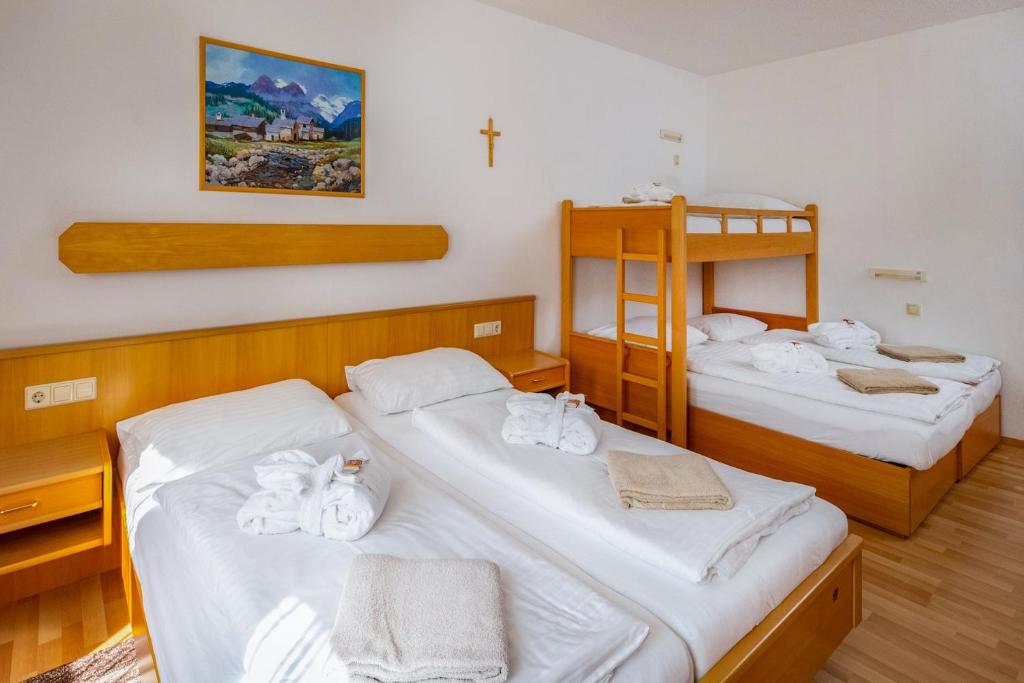 A bed or beds in a room at Waldschlössl Gasthof