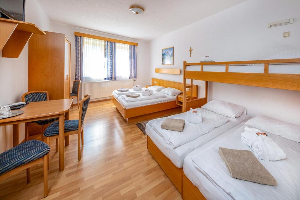 A bed or beds in a room at Waldschlössl Gasthof