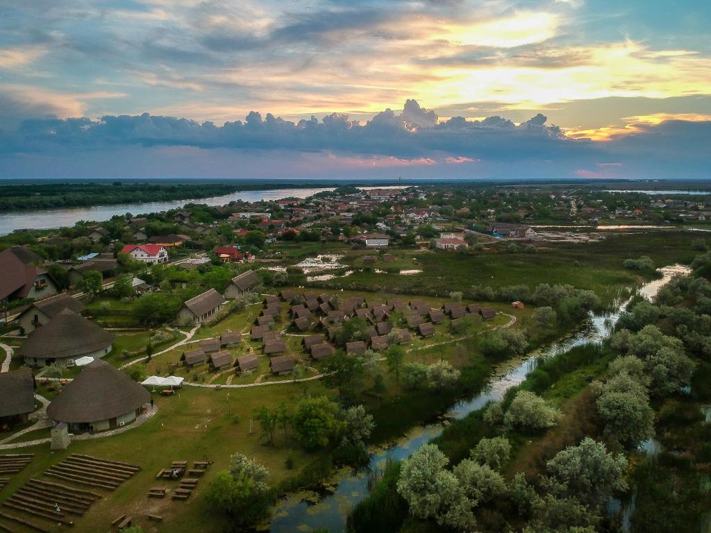 an aerial view of a village next to a river at Dolphin Camping in Sfântu Gheorghe