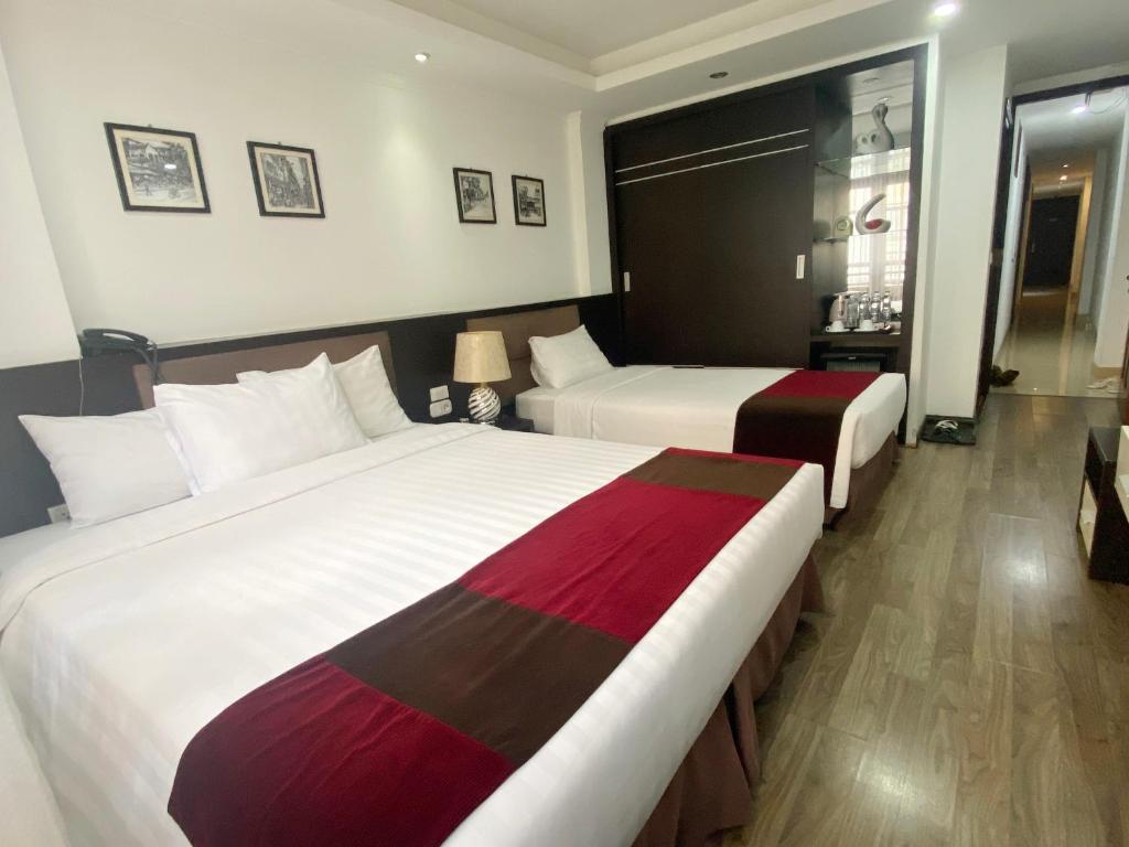 Postel nebo postele na pokoji v ubytování Parklane Central Hanoi Hotel
