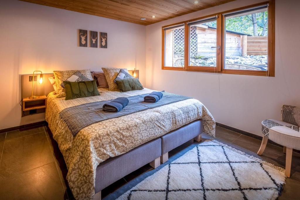 a bedroom with a bed and a window at Chalet 65bis - OVO Network in Thônes