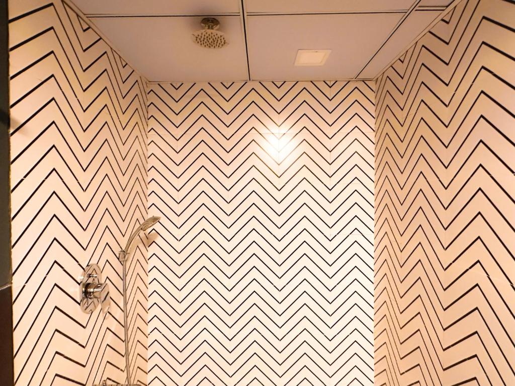 a room with a chevron pattern on the wall at Hoztel Jaipur in Jaipur
