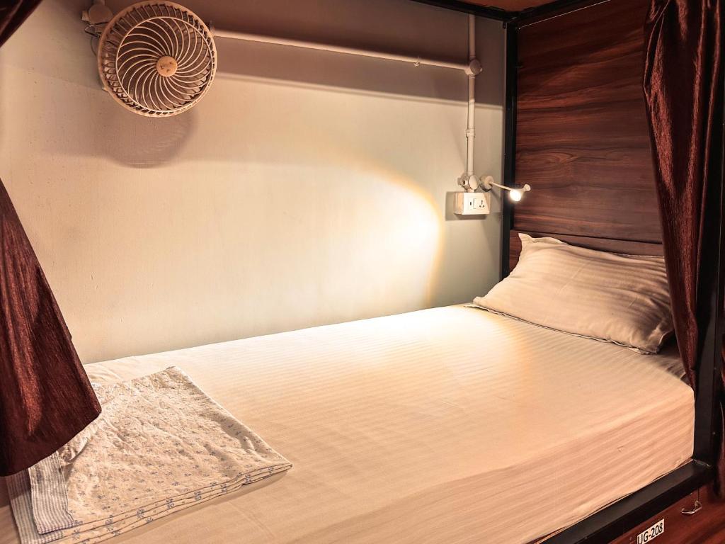 a bedroom with a bed with a fan on it at Hoztel Jaipur in Jaipur