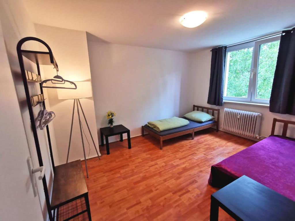 a living room with a bed and a window at Monteurzimmer Berlin Neukölln in Berlin