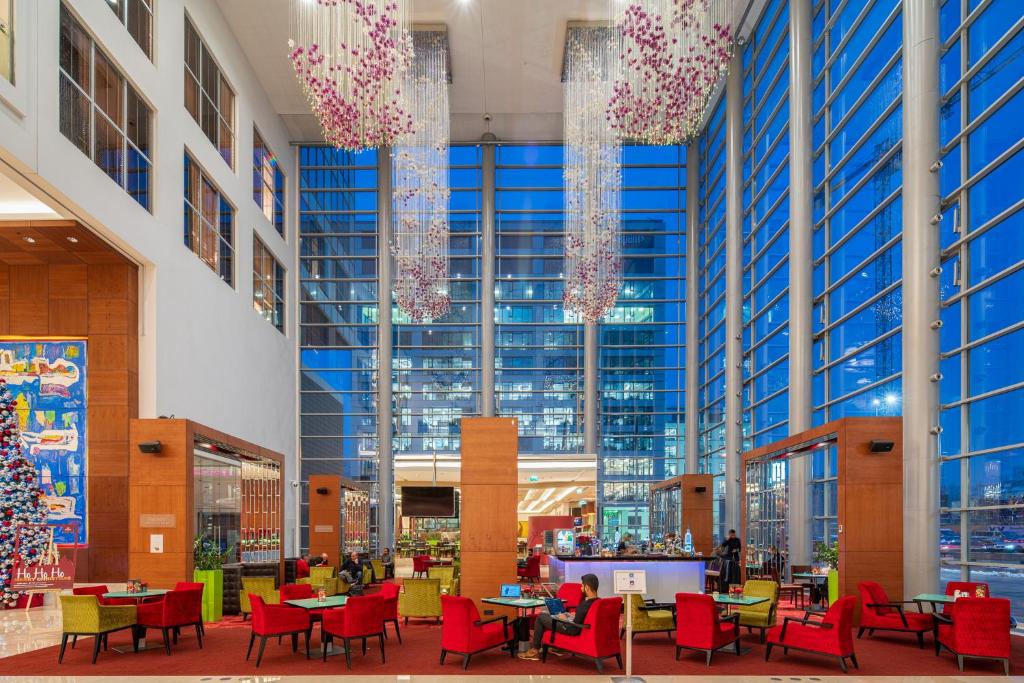 a large building with tables and chairs and christmas decorations at Hilton Warsaw City Hotel in Warsaw