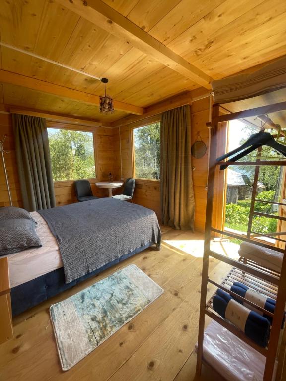 a bedroom with a bed in a wooden cabin at House in The Mountains in Khulo