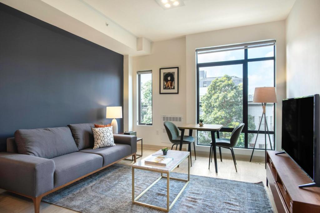 a living room with a couch and a table at Hayes Valley Studio w Rooftop WD 1 min to BART SFO-108 in San Francisco