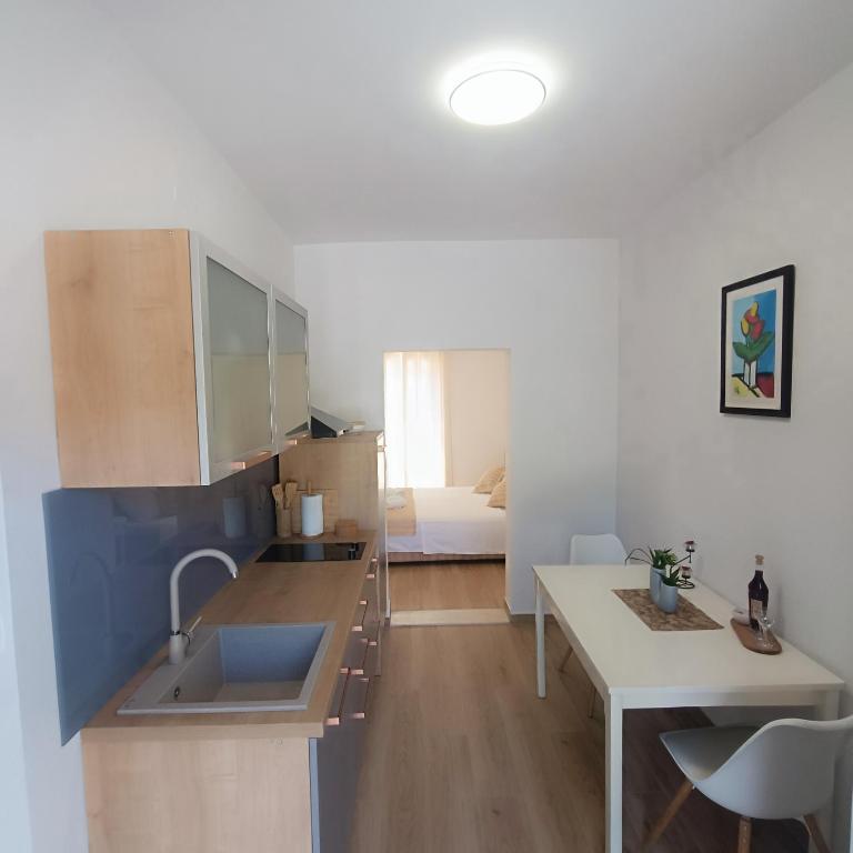 a kitchen with a sink and a desk in a room at Villa Fragola 3 in Doli