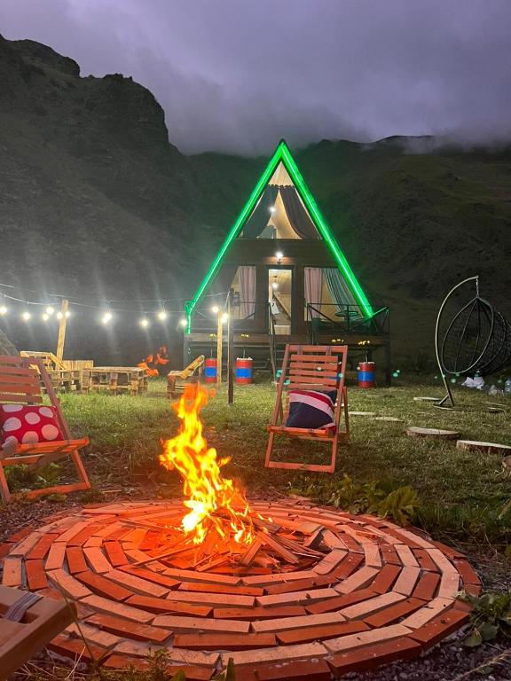 a fire pit in front of a gazebo at Gudika • გუდიკა in Sno