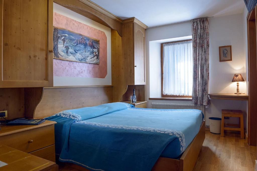 Postel nebo postele na pokoji v ubytování Albergo Miravalle-Tre Cime Views