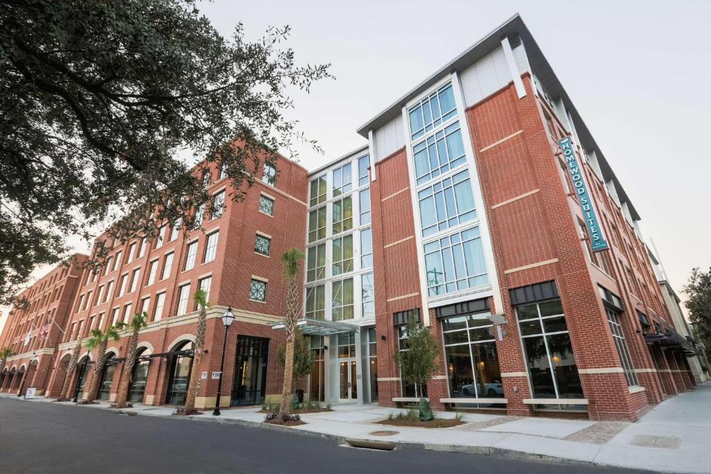 a large brick building with windows on a street at Homewood Suites By Hilton Charleston Historic District in Charleston
