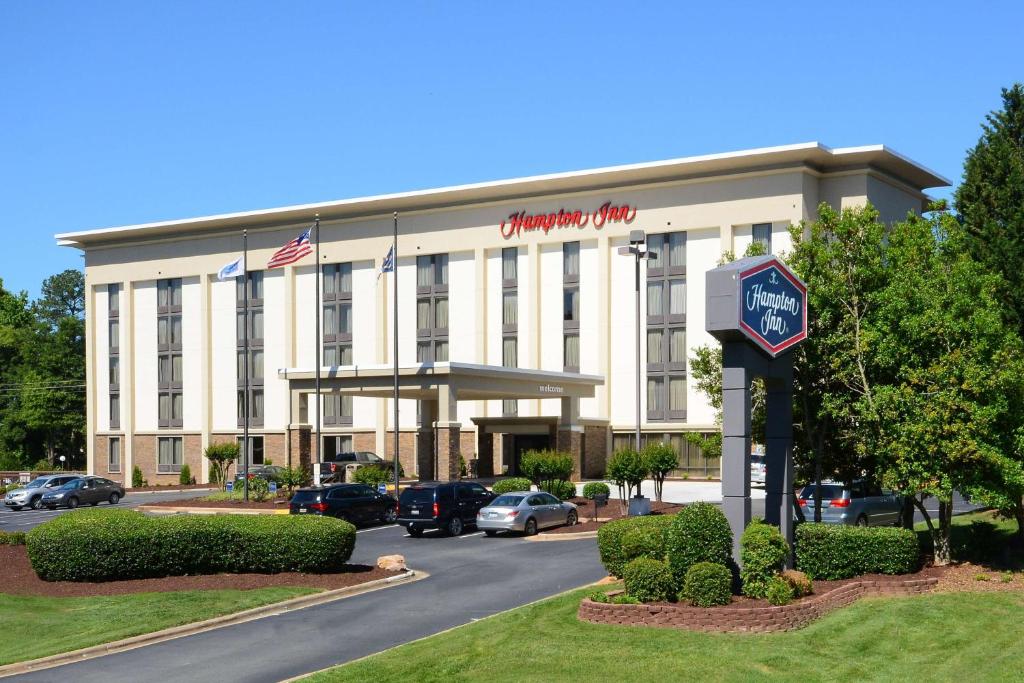 a hotel building with a clock in front of it at Hampton Inn Charlotte North Lake Norman in Cornelius