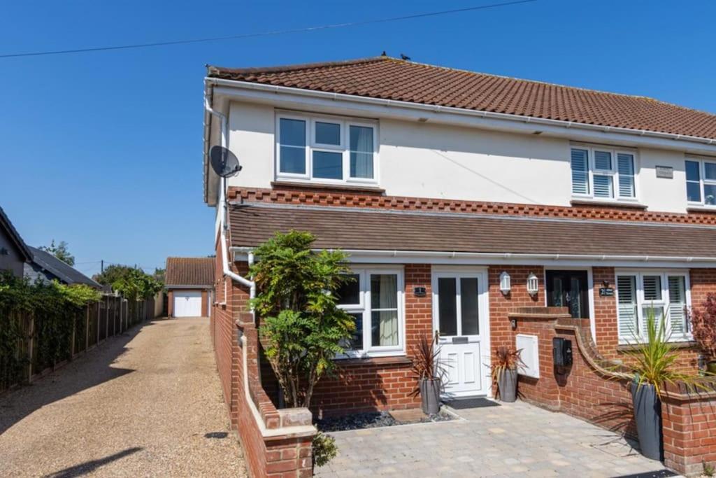 een stenen huis met een hek en een oprit bij 1 Albert Terrace - Southwold in Reydon