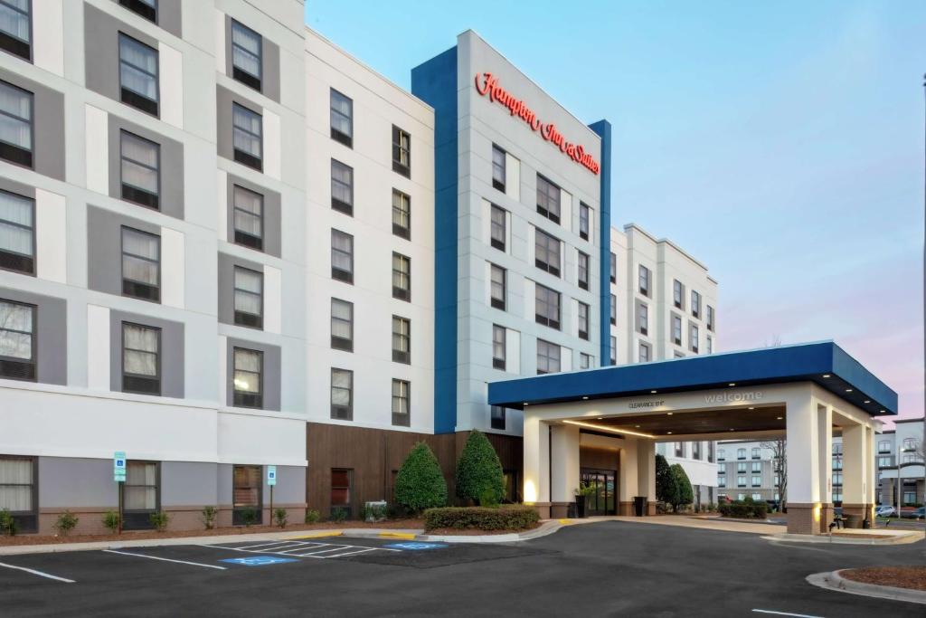 a rendering of the front of a hotel with a parking lot at Hampton Inn & Suites Concord-Charlotte in Concord