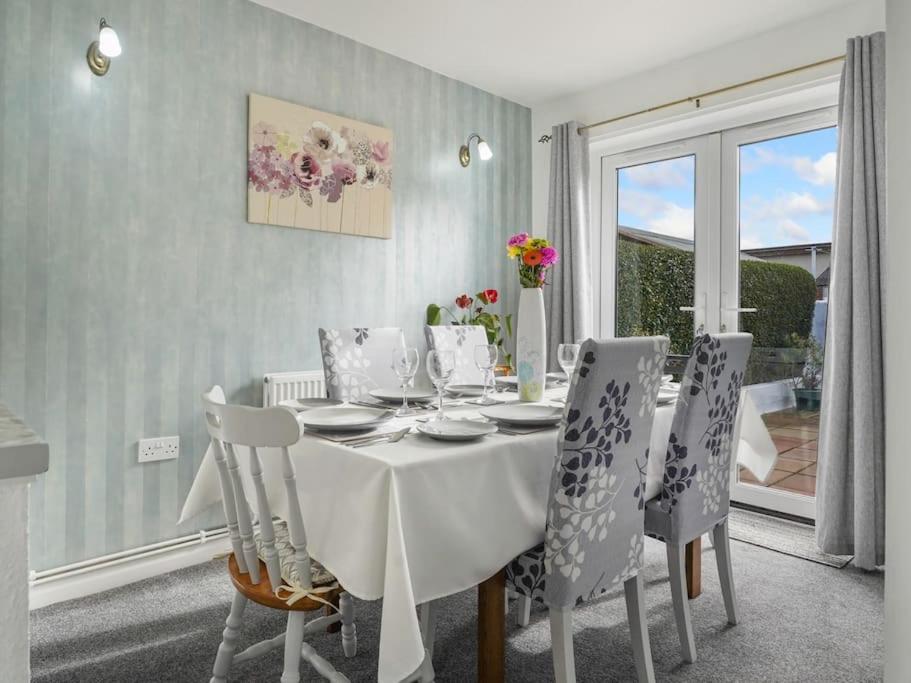 a dining room with a white table and chairs at River View Walk - Fab 3B House in Aberystwyth