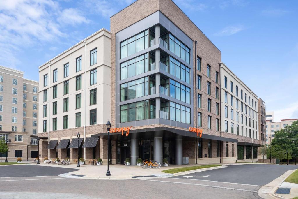 a building on a street in front of a road at Canopy By Hilton Charlotte SouthPark in Charlotte