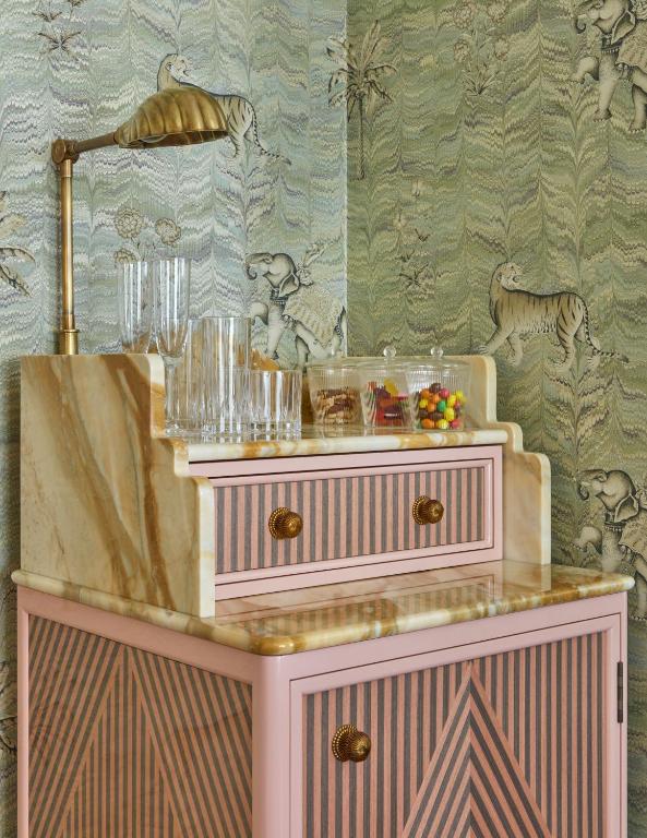 a pink dresser with a mirror on top of it at Broadwick Soho in London
