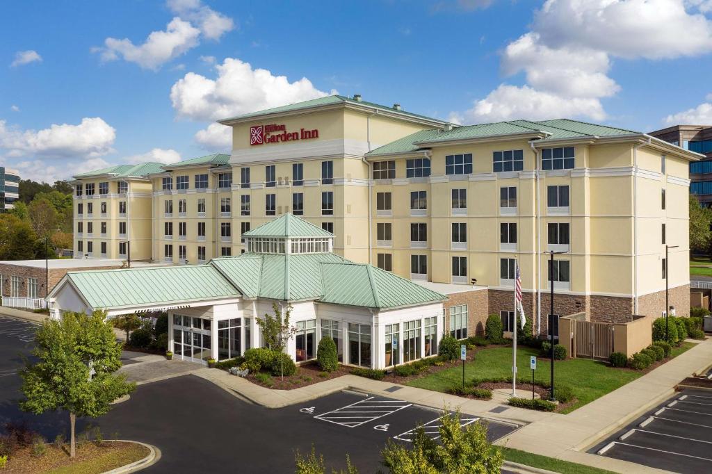 an aerial view of a hotel with a parking lot at Hilton Garden Inn Charlotte Airport in Charlotte