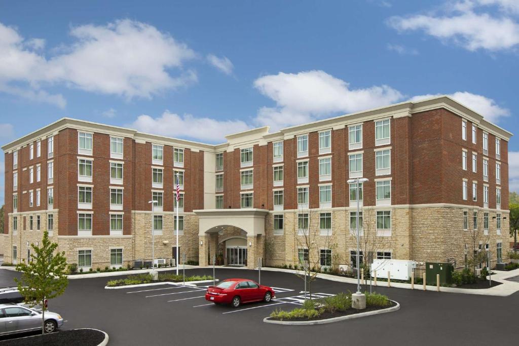 a rendering of a building with a red car in a parking lot at Homewood Suites by Hilton Columbus OSU, OH in Columbus