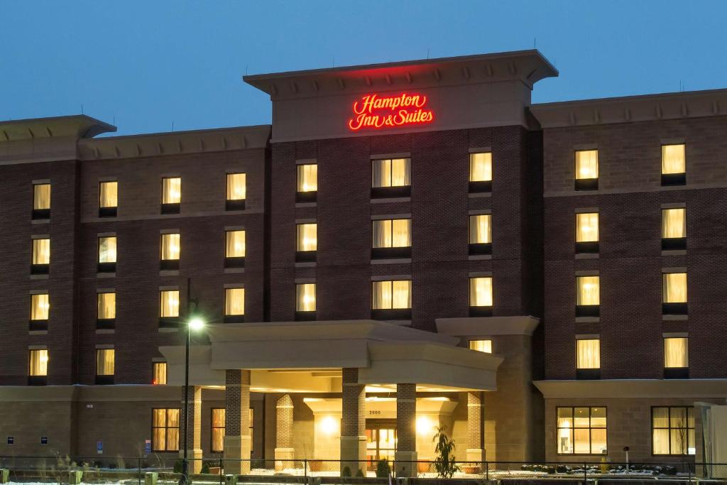 a hotel with a red sign on top of it at Hampton Inn & Suites - Cincinnati/Kenwood, OH in Cincinnati