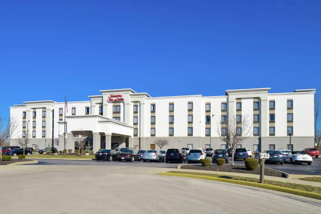 a large white building with cars parked in front of it at Hampton Inn & Suites Wilmington in Wilmington