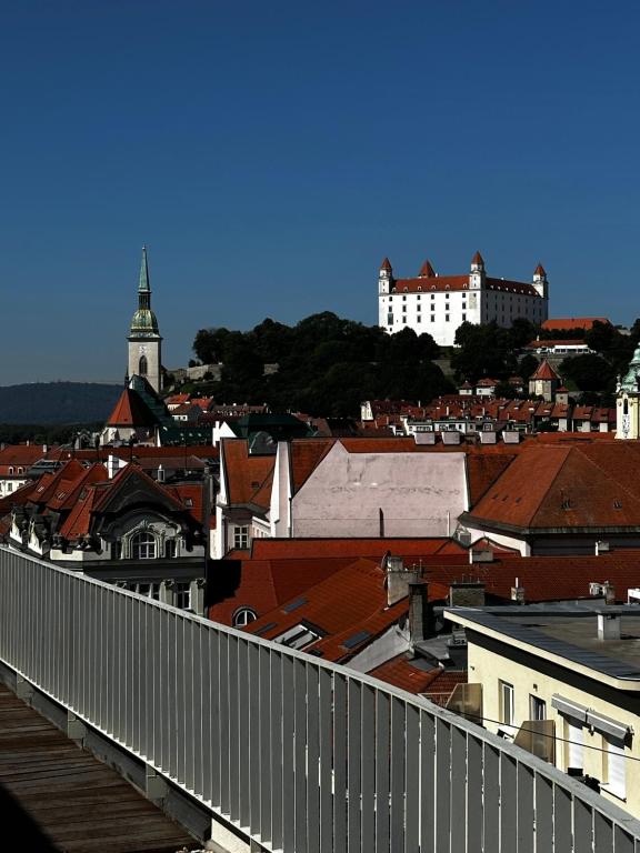 a view of a city with roofs and buildings at Luxury PENTHOUSE at the Historical Centre with free parking in Bratislava