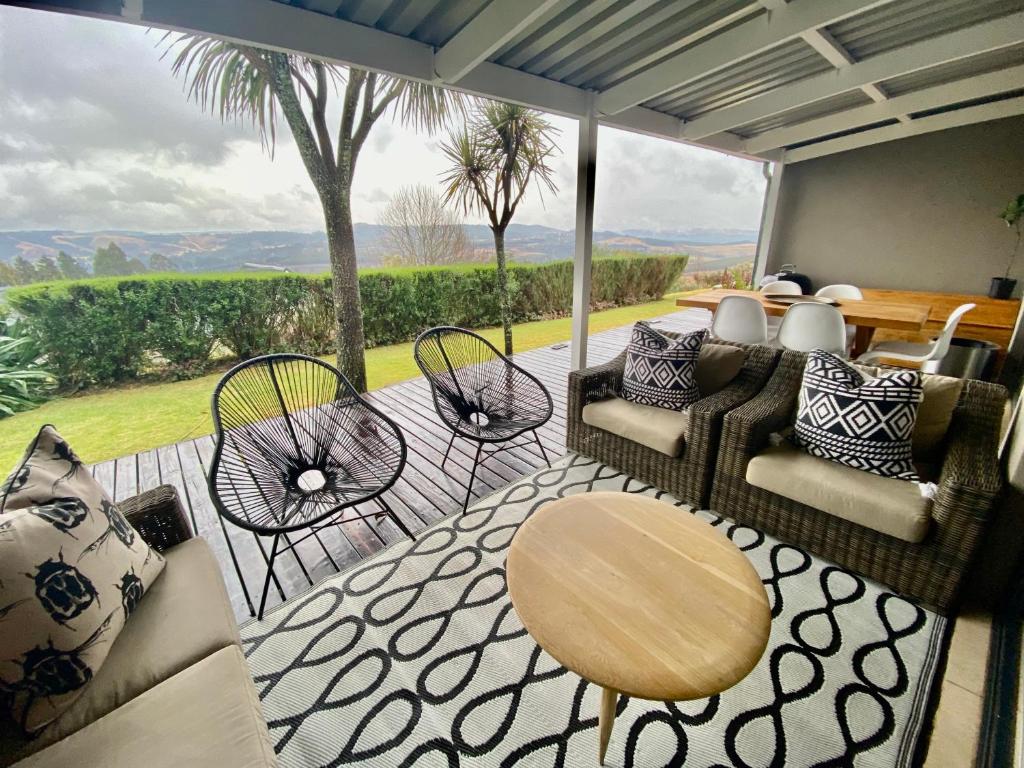 a patio with chairs and a table with a view at WildCroft 20 in Balgowan