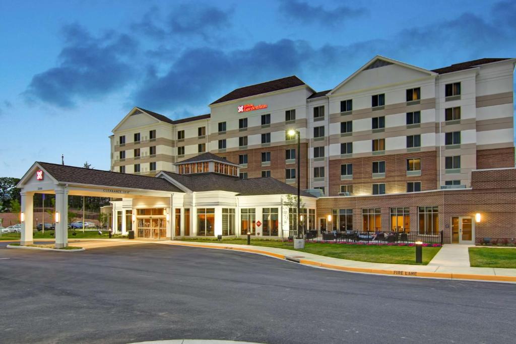 a hotel with a parking lot in front of it at Hilton Garden Inn Woodbridge in Woodbridge