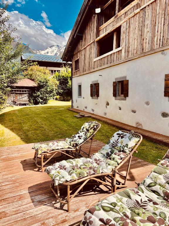 two lounges on a deck in front of a building at Wanderful Life MontBlanc refuge haut de gamme in Saint-Gervais-les-Bains