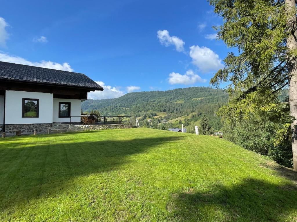 a large grassy yard next to a house at Panorama in Slavske