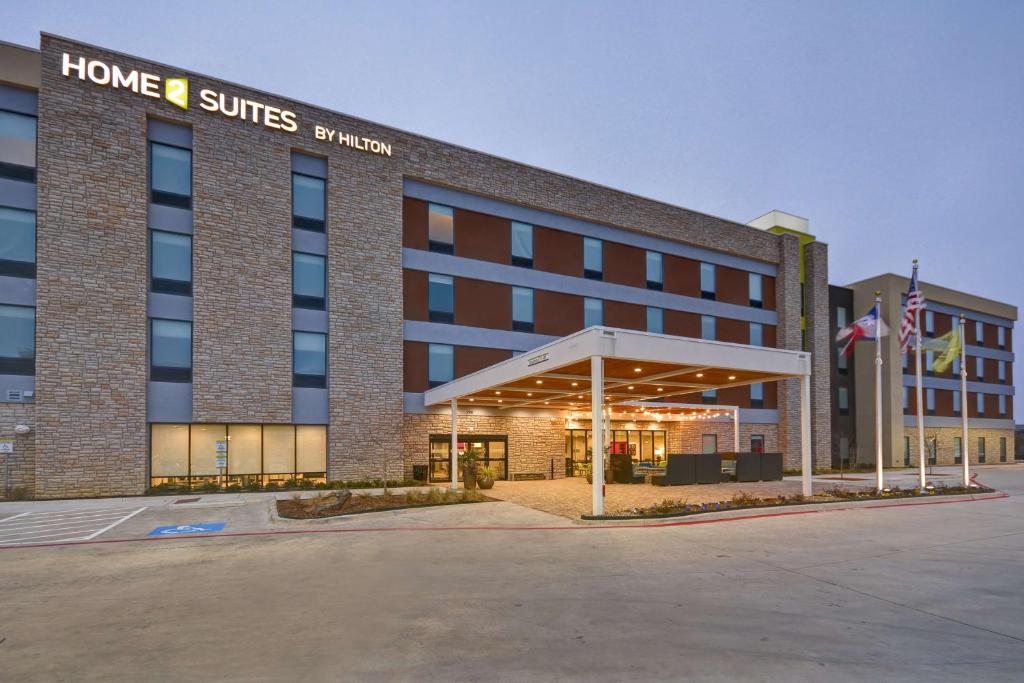 a hotel building with a sign that reads home suites of america at Home 2 Suites By Hilton Fairview Allen in Fairview