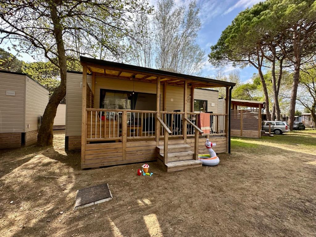 a small house with a playground with a slide at Estivo Premium Deluxe mobile homes on Camping Ca Savio in Cavallino-Treporti