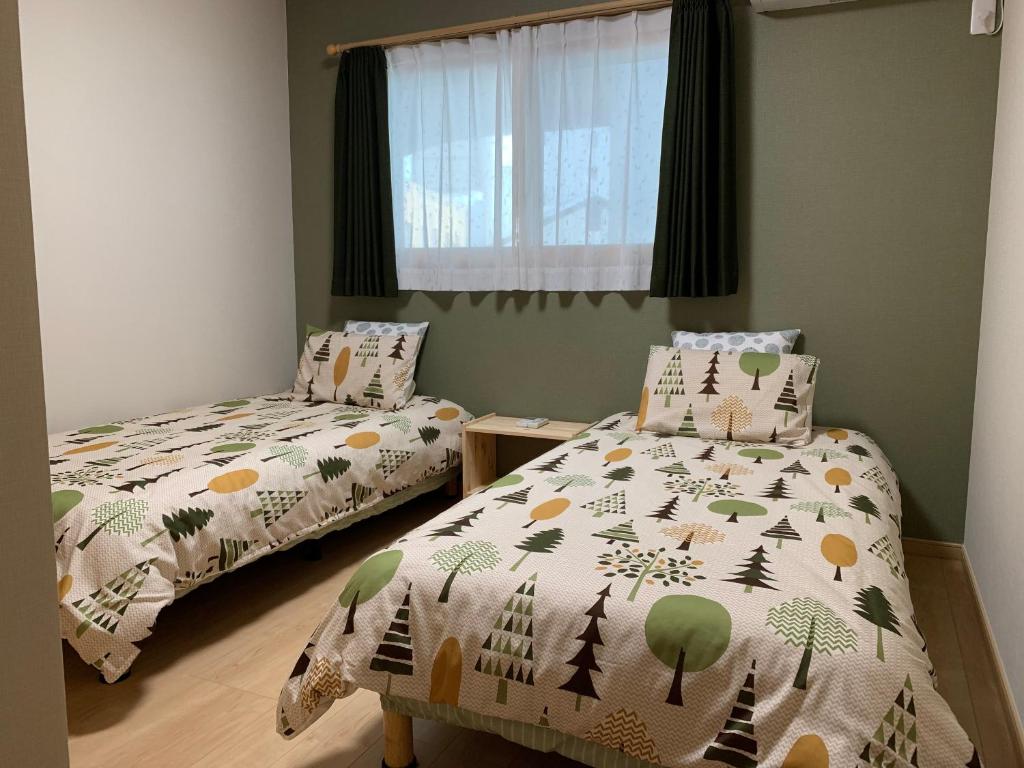 Postel nebo postele na pokoji v ubytování Guesthouse Kaede Annex