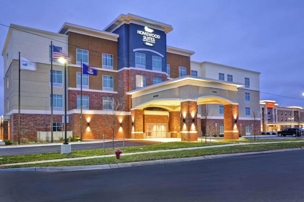 a hotel building with a fire hydrant in front of it at Homewood Suites By Hilton Warren Detroit in Warren