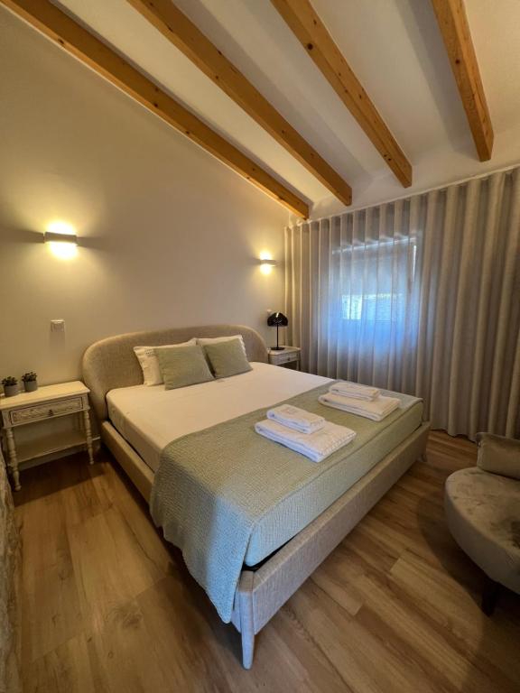a bedroom with a large bed and a window at Douro Pateo House in Vila Nova de Gaia