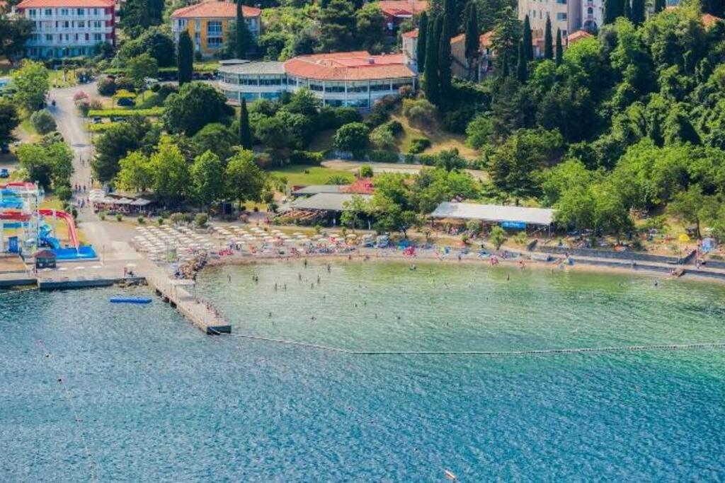 a beach with a bunch of people in the water at Room 400 m from the beach in Izola