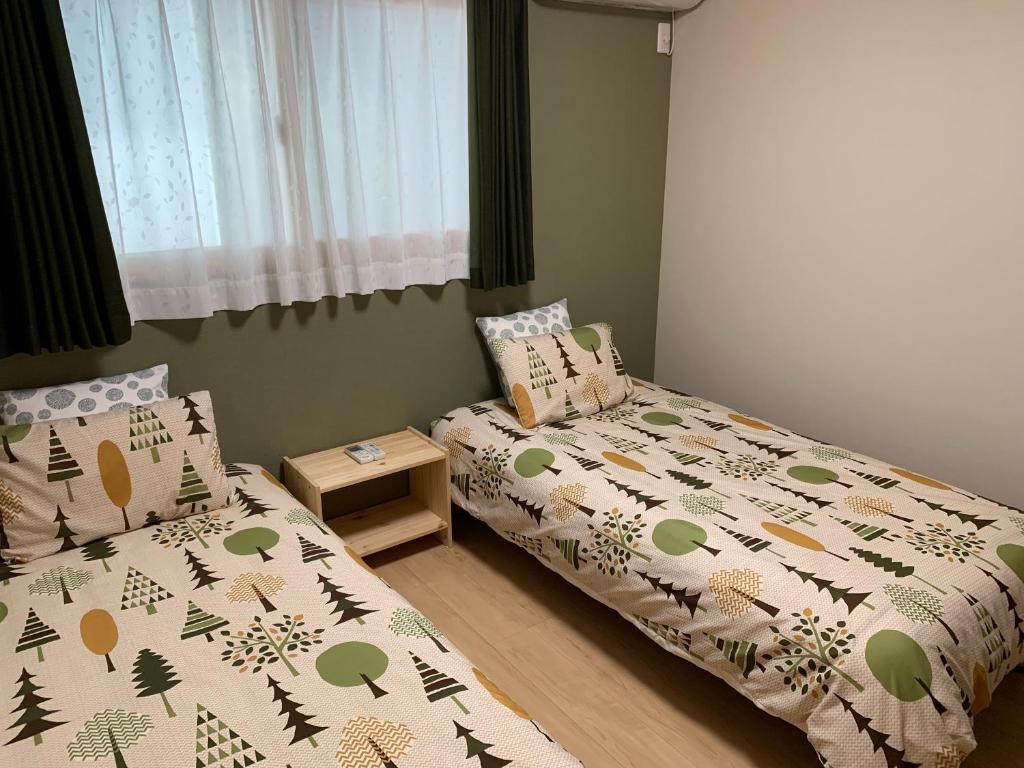 Postel nebo postele na pokoji v ubytování Guesthouse Kaede Annex