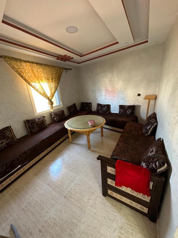 sala de estar con sofá y mesa en Apartement pret de la gare train, en Nador