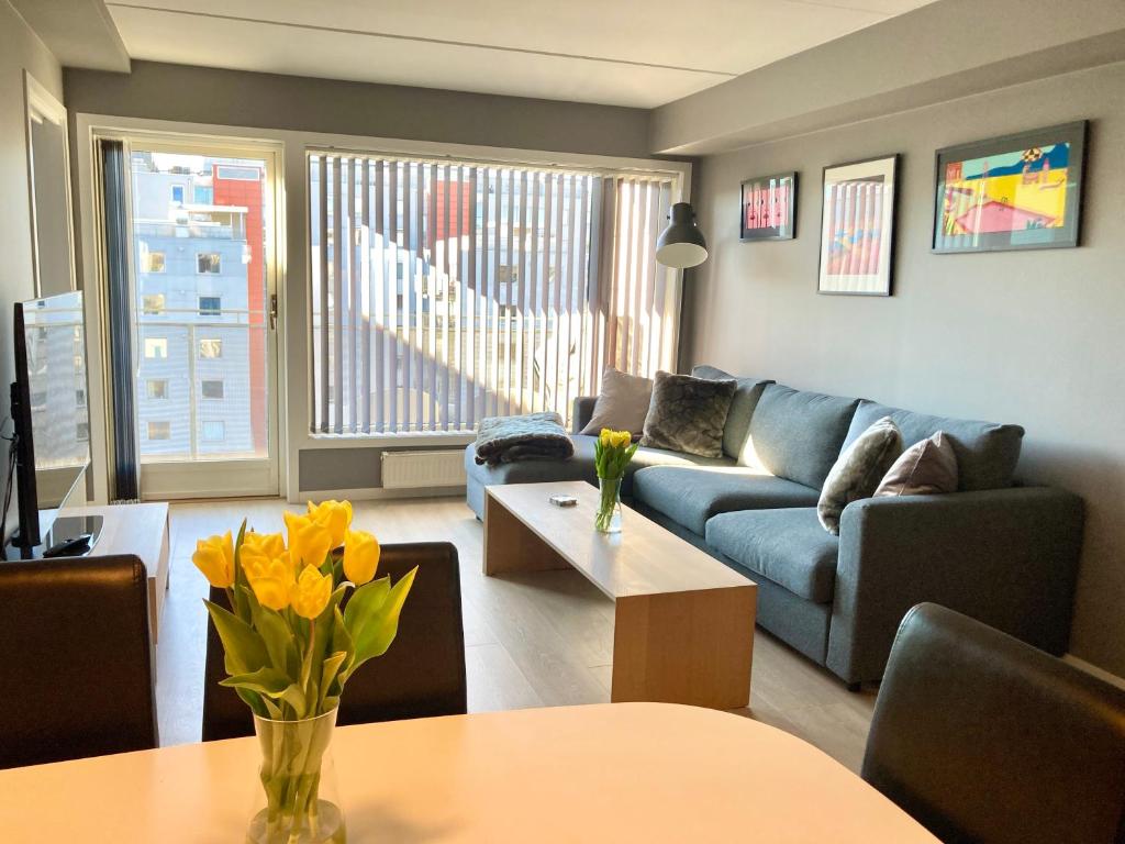 a living room with a blue couch and a table at Modern 2 bedroom apartment in Oslo city centre in Oslo