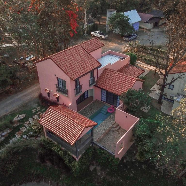an overhead view of a pink house with red roofs at Pink Villa by Tubtao Sleepy Hill in Pong Talong