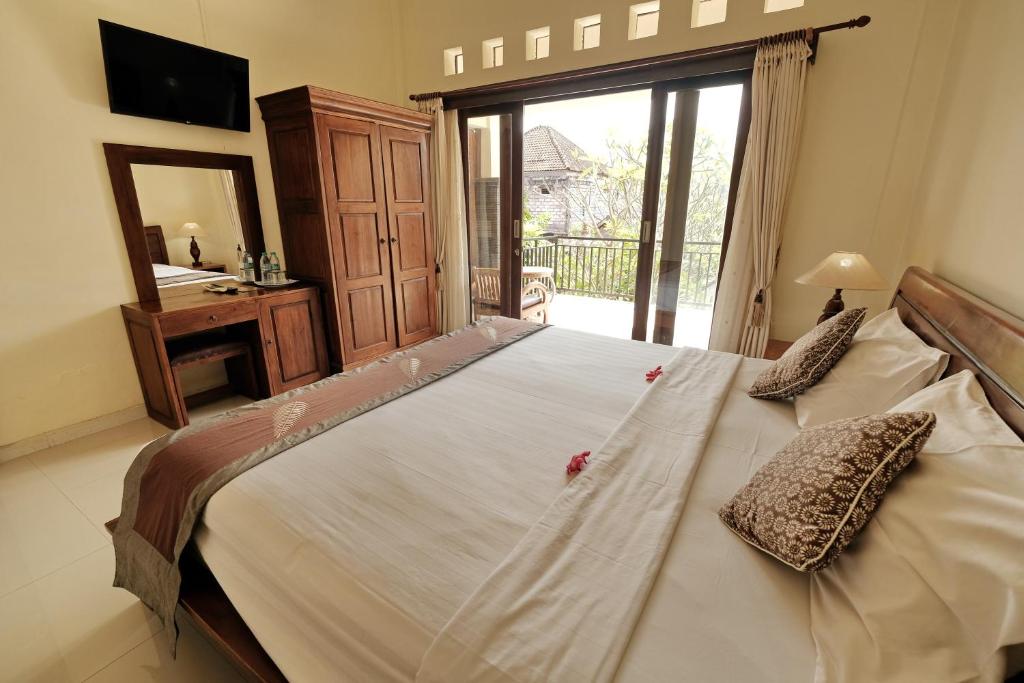 Postel nebo postele na pokoji v ubytování Sumantra Guest House
