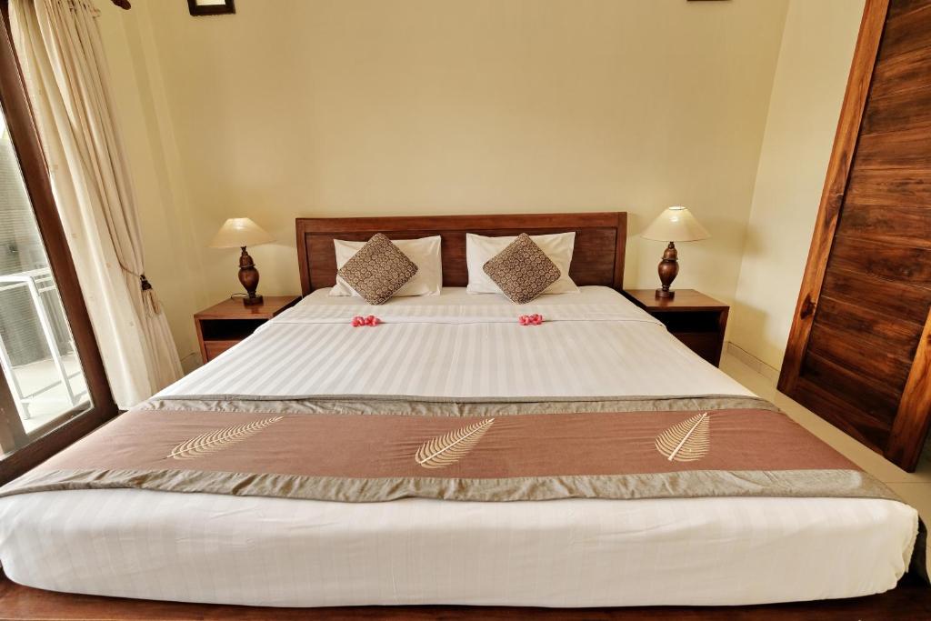 Postel nebo postele na pokoji v ubytování Sumantra Guest House