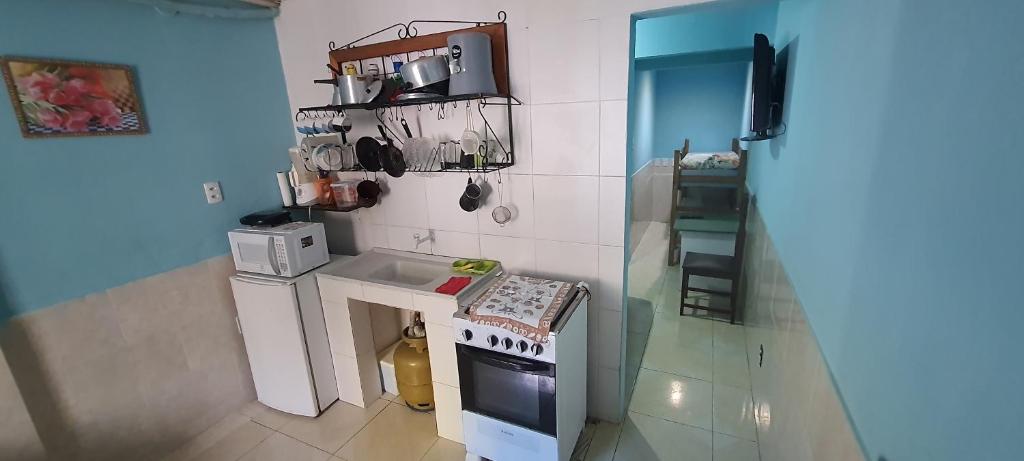 una pequeña cocina con fogones y fregadero en Kitnets Itapuã Residência - 1 Minuto de Caminhada Ate a Praia en Salvador
