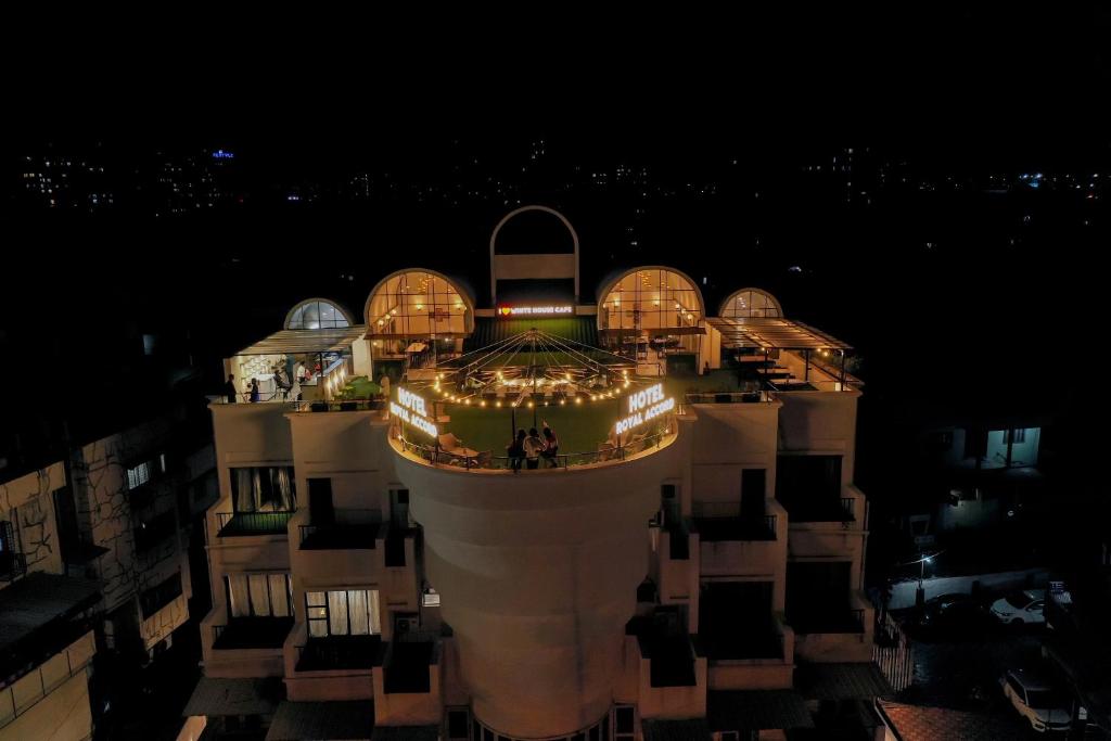 a large building with lights on it at night at Hotel Royal Accord in Surat