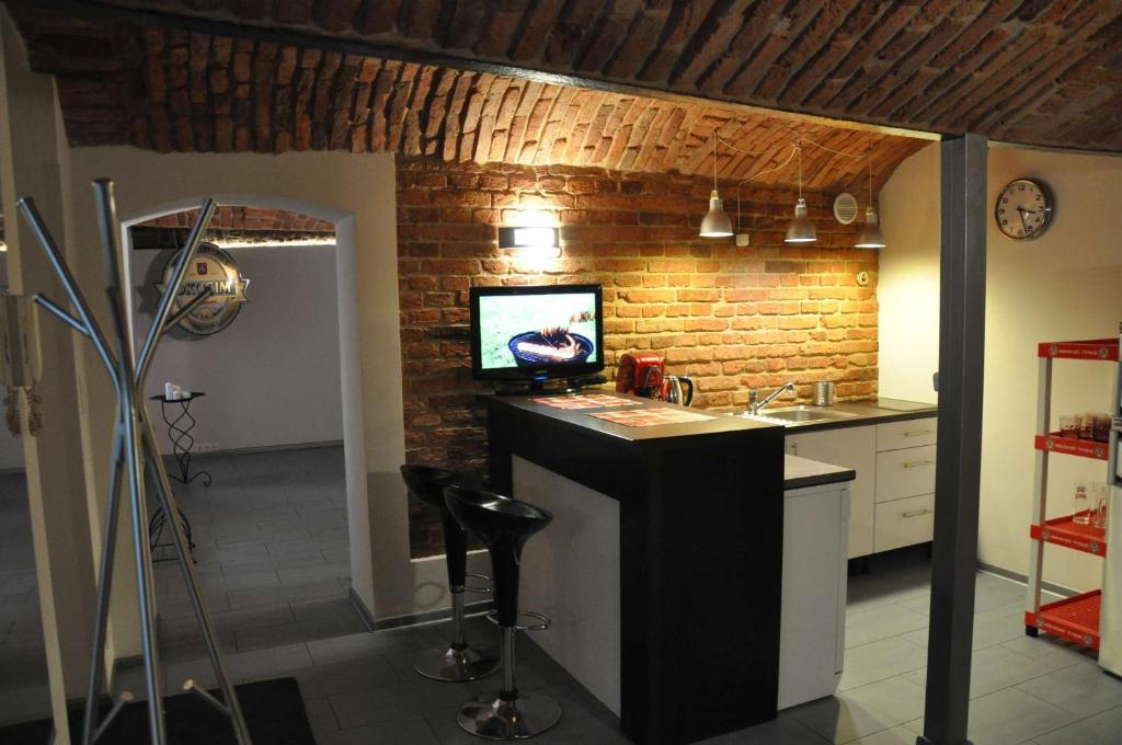 a kitchen with a sink and a brick wall at Topola in Krakow