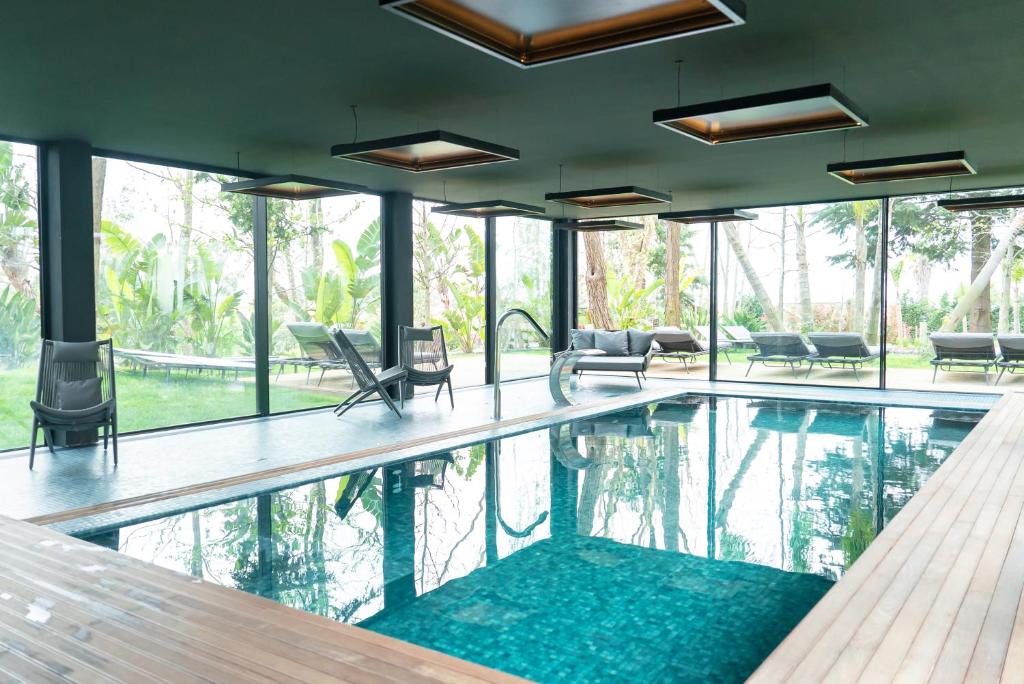 a swimming pool in a house with windows at Quinta de Silvalde in Santo Tirso