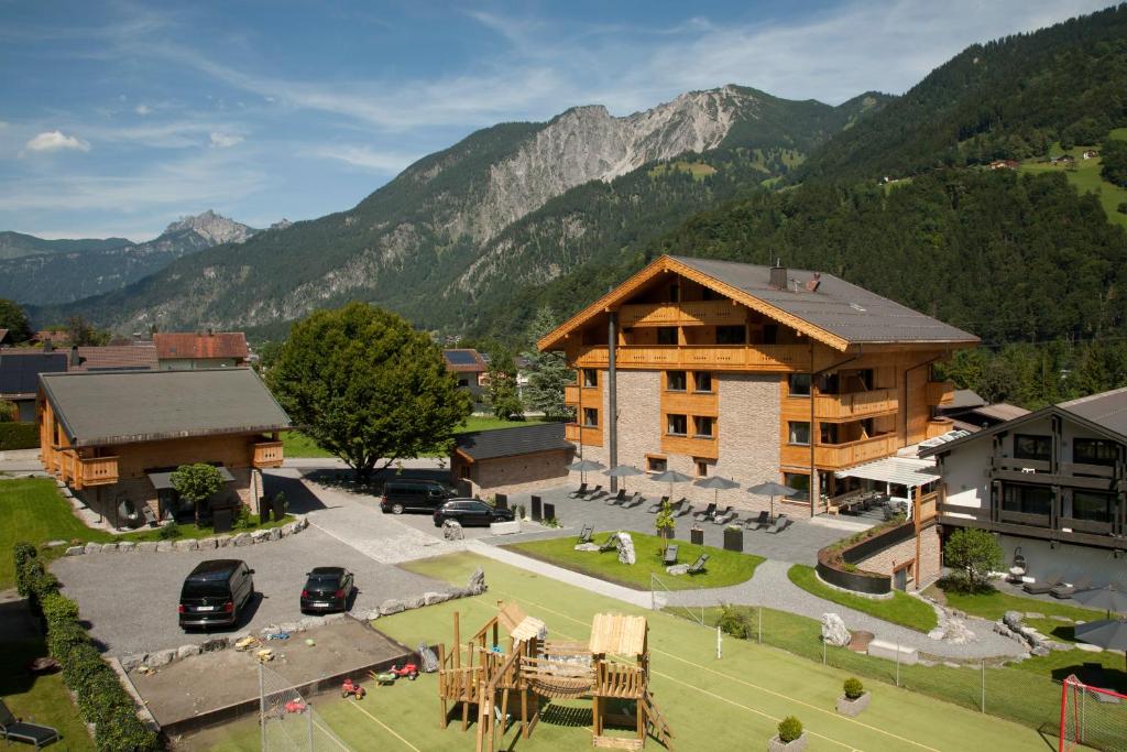 an aerial view of a lodge with mountains in the background at Hotel Die Montafonerin in Vandans